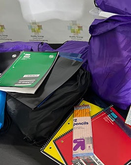 Back-to-school supplies — backpacks, notebooks, and pencils for the giveaway